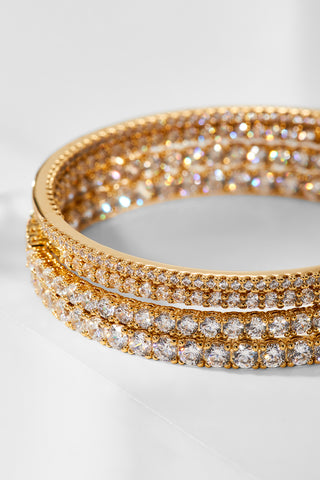Image of large hoop earrings with various size cubic zirconia stones stacked on top of one another.
