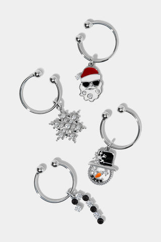 Set of four Christmas-themed wine charms on a white background. The charms include a santa clause wearing sunglasses, a snowflake, a candy cane, and a snowman.