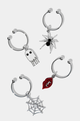 Set of four Halloween-themed wine charms on a white background. Charms include a ghost, spider, spiderweb, and red lips with vampire fangs.