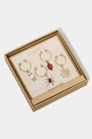 Set of four Halloween-themed wine charms in a Nadri box. Charms include a ghost, spider, spiderweb, and red lips with vampire fangs.