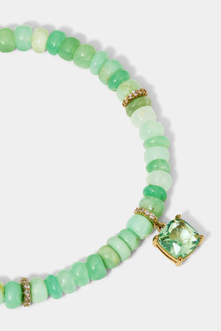 CLOSE UP OF THE CUSHION CHARM ON THE BEADS OF PARADISE GREEN CUSHION BOLO BRACELET
