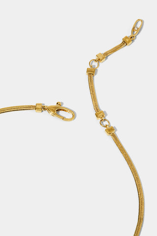 Close up image of gold-plated necklace's lobster clasp closure with two extension rings.
