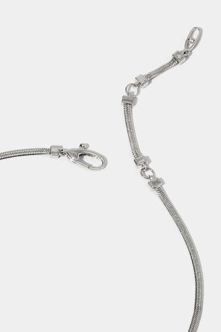 Close up image of rhodium-plated necklace's lobster clasp closure with two extension rings.