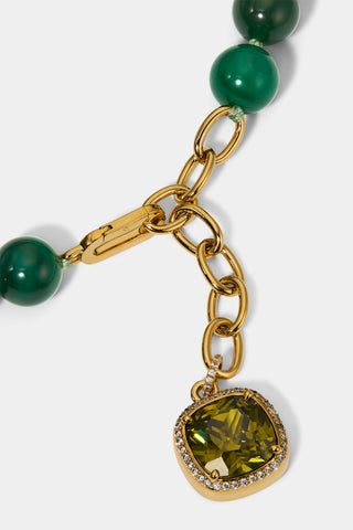CLOSE UP OF THE CUSHION CHARM ON THE BEADS OF PARADISE GREEN ADJUSTABLE Y NECKLACE