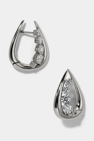 PHENOM HUGGIE EARRINGS IN RHODIUM PLATING