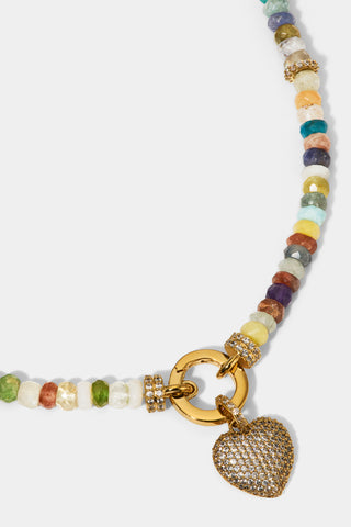 CLOSE UP OF THE HEART CHARM ON THE BEADS OF PARADISE SMALL HEART PENDANT NECKLACE
