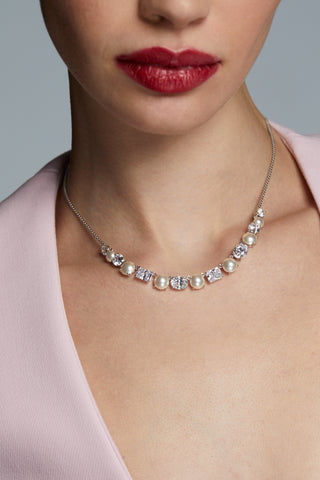 CLOSE UP IMAGE OF MODEL WEARING LONDON MIXED CZ AND PEARL FRONTAL NECKLACE AND A PINK DRESS.