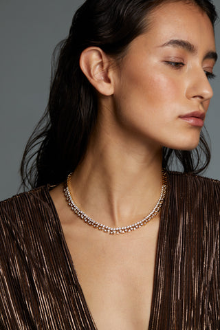 LUXOR CZ COLLAR NECKLACE ON MODEL. SHE IS WEARING A METALLIC GOLD DRESS, LOOKING SIDEWAYS. NECKLACE IS IN FULL FRONTAL VIEW. 