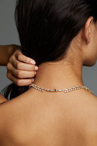 BACK OF MODEL WEARING LUXOR CZ LARGE COLLAR NECKLACE SO THAT THE CLASP IS VISIBLE ON THE BACK OF HER NECK SHOWING INTRICATE DETAILS.