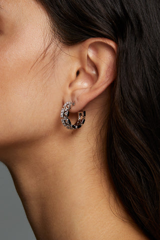 LUXOR CZ SMALL C HOOPS EARRINGS ON MODEL. IT IS A CLOSE UP IMAGE OF HER EAR. SHE IS FACING TO THE SIDE WITH HAIR BEHIND THE EARS WITH HOOP EARRINGS VISIBLE. 