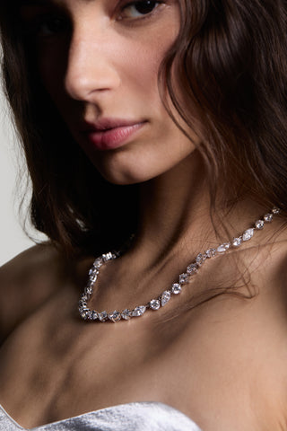 CLOSE UP OF A MODEL’S CHEST AND CHIN, HIGHLIGHTING THE LUCIA MIXED CZ NECKLACE