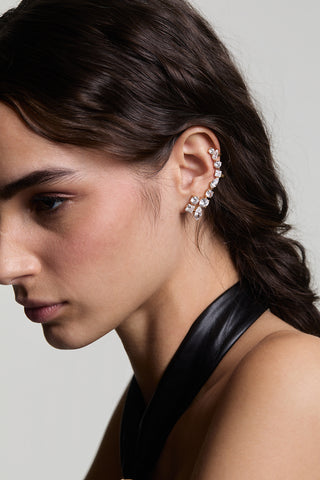 CLOSE UP OF A SIDE-PROFILE VIEW OF A MODEL LOOKING AWAY WEARING LUCIA SINGLE ADJUSTABLE CLIMBER EARRINGS, STYLED WITH A BRAID AND A BLACK TOP