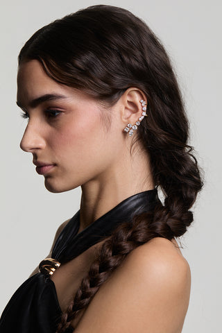 SIDE-PROFILE VIEW OF A MODEL LOOKING AWAY WEARING LUCIA SINGLE ADJUSTABLE CLIMBER EARRINGS, STYLED WITH A SIDE BRAID AND A BLACK TOP