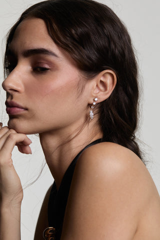 SIDE PROFILE OF A MODEL WEARING LUCIA J HOOP DROP EARRINGS, WITH HER HAIR TUCKED BEHIND HER EAR AND A BLACK TOP
