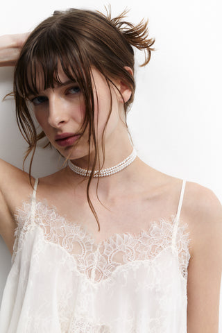 MODEL WEARING MADRID 4MM  PEARL CHOKER NECKLACE WITH A WHITE LACE TOP WHILE HOLDING HER HAIR UP IN A BUN.
