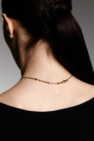 Image shows model from behind with a close up of the necklace closure. It has a traditional lobster clasp.