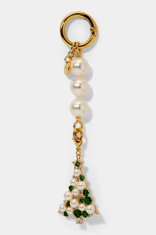 Christmas tree shaped bag charm with pearl, cubic zirconia, and green stone embellishments hanging from a pearl chain. 