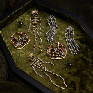 flatlay image of Halloween capsule items on a green velvet prop coffin.