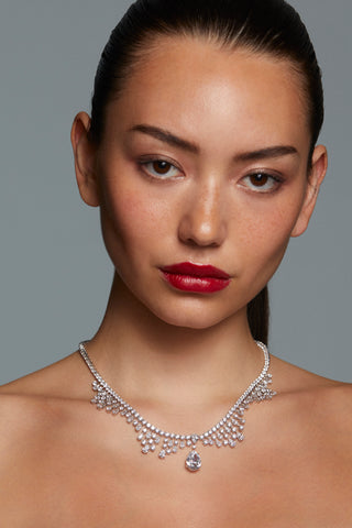 Model in strapless dress wearing silver statement necklace with pear-cut CZ centerpiece