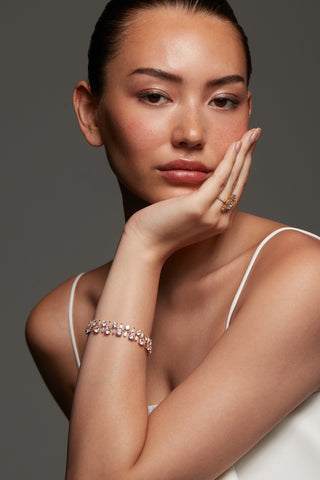 MODEL WEARING STELLAR CZ LINE BRACELET. HER CHIN IS RESTING ON HER HAND. SHE IS WEARING A WHITE SPAGHETTI STRAP TOP WITH HER HAIR PULLED BAKC INTO A PONYTAIL. 
