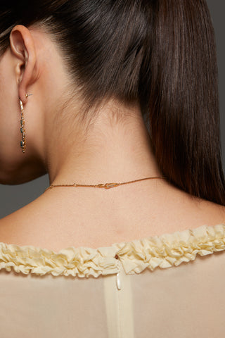 BACK IMAGE OF MODEL WEARING STELLAR CZ Y NECKLACE SHOWING A DETAIL OF THE CHAIN AND CLASP. 