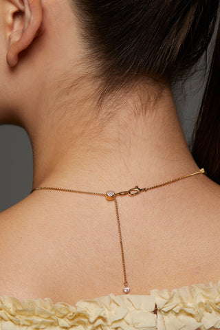 BACK IMAGE OF MODEL WEARING STELLAR CZ SLIDER COLLAR NECKLACE SHOWING DETAIL OF THE ADJUSTABLE BOLO CLOSURE. 
