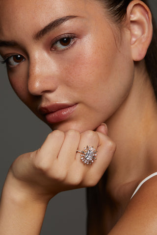 CLOSE UP OF MODEL WITH HAND ON HER CHIN WEARING STELLAR CZ HALO RING