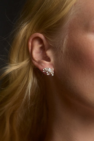 CLOSE UP OF A MODEL'S EAR AS SHE WEARS THE CANNES STUD EARRINGS