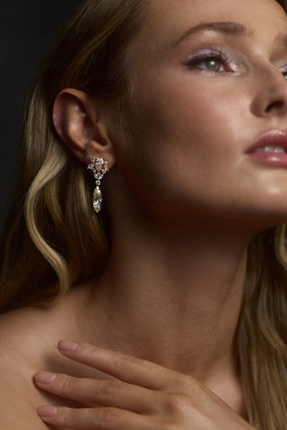 CLOSE UP OF A MODEL LOOKING UPWARD, WEARING THE CANNES DROP EARRINGS