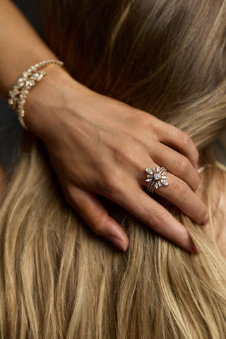 CLOSE UP OF A MODEL'S HAND ON THE BACK OF HER NECK, AS SHE BRUSHES HER BLONDE HAIR TO THE SIDE AND WEARS THE CANNES LARGE STACK RING