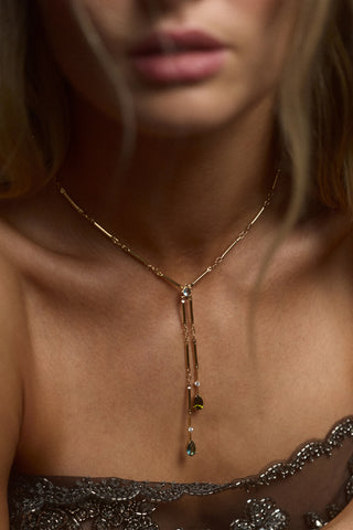 CLOSE UP OF A MODEL’S CHEST WEARING A BLACK TOP AND THE HERA MULTI FAUX LARIAT NECKLACE