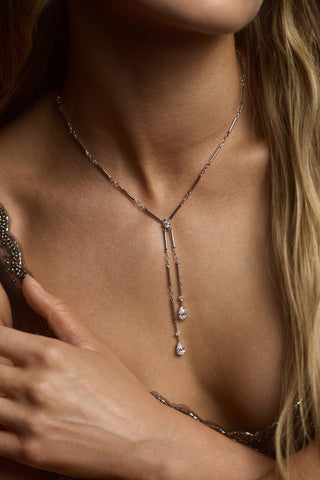 CLOSE UP OF A MODEL’S CHEST WEARING THE HERA FAUX LARIAT NECKLACE