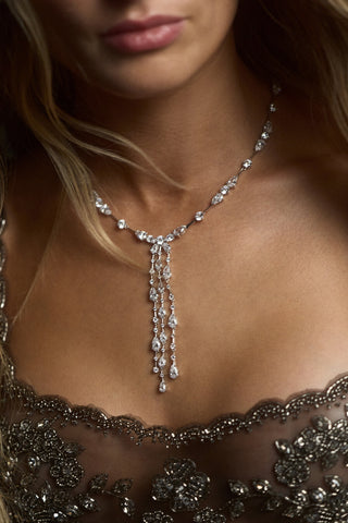 CLOSE UP OF A MODEL’S CHEST WEARING A SHEER BLACK DRESS AND THE HERA DRAMA Y NECKLACE