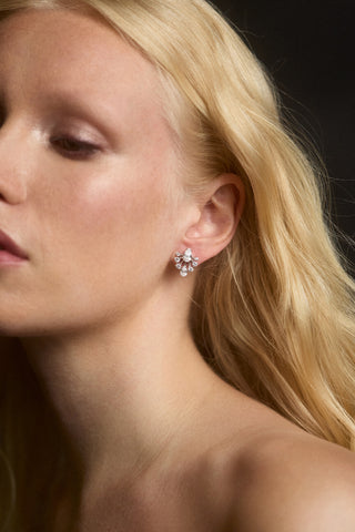 CLOSE UP OF A MODEL WITH BLONDE HAIR WEARING THE HERA LARGE FAN STUD EARRINGS