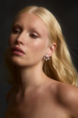 MODEL WITH BLONDE HAIR LOOKING SLIGHTLY TO THE SIDE WEARING THE HERA FRONTBACK EARRINGS