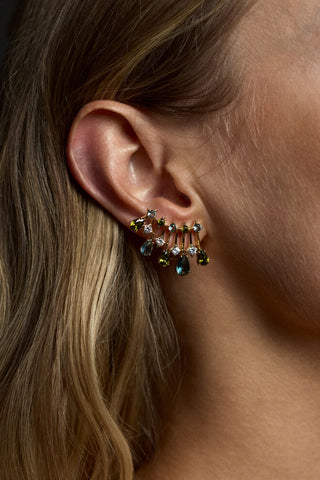 CLOSE UP OF A MODEL’S EAR WEARING THE HERA MULTI COLOR CLIMBER EARRINGS
