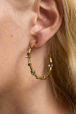 CLOSE UP OF A MODEL’S EAR WEARING THE HERA MULTI ELONGATED HOOP EARRINGS