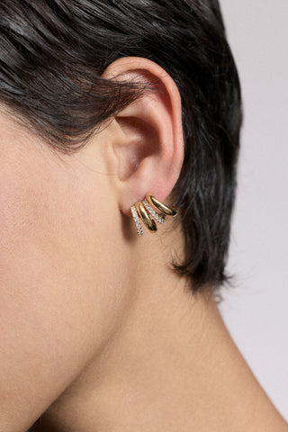 CLOSE UP OF A MODEL’S EAR WITH SHORT BLACK HAIR WEARING THE MUSE MULTI J STUD EARRINGS