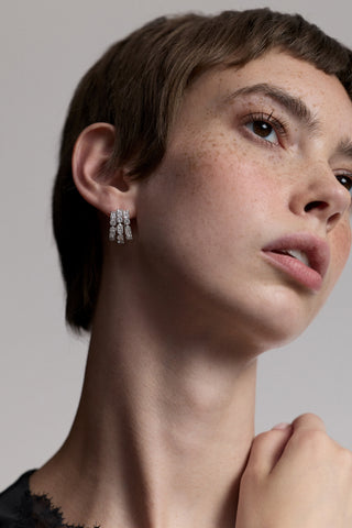 CLOSE UP OF A MODEL WITH SHORT RED HAIR LOOKING UPWARD, WEARING THE TWINNIE SMALL MULTI HOOP EARRINGS