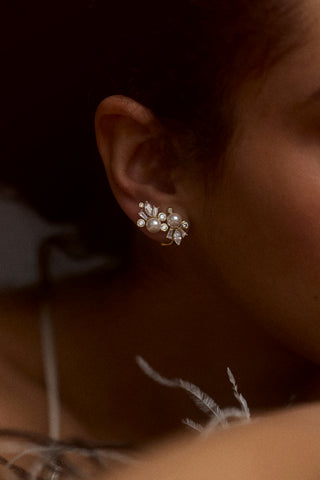 CLOSE UP OF A MODEL’S EAR WEARING THE UNDER THE SEA CLIMBER STUD EARRINGS