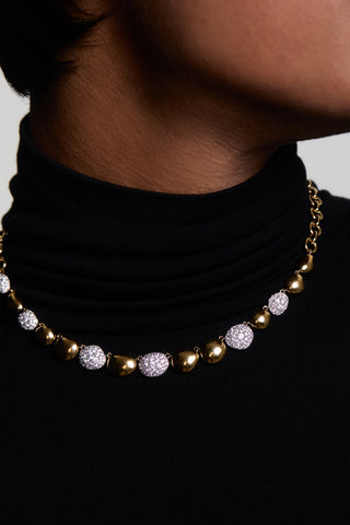 CLOSE UP OF A MODEL’S NECK WEARING A BLACK TURTLENECK AND THE PEBBLES FRONTAL NECKLACE