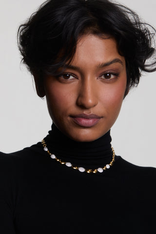 A MODEL LOOKING AT THE CAMERA WEARING A BLACK TURTLENECK AND THE PEBBLES FRONTAL NECKLACE