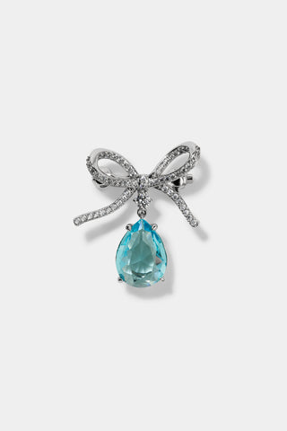 CEREMONY SWAG AQUA BOW PIN BAG CHARM IN RHODIUM PLATING