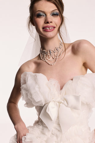 A MODEL WEARING THE PEARL CHOKER ORNATE HIGH NECKLACE STYLED WITH A LAYERED TULLE WEDDING GOWN