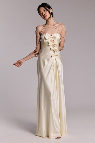 MODEL POSING IN A WEDDING DRESS WITH BOW DETAILING, STYLED WITH THE PEARL CHOKER SHOULDER SWAG NECKLACE