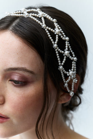 CLOSE UP OF A GIRL’S HEAD WITH HER HAIR IN A BRAID BEHIND HER, AND THE PR LATTICE HAIR GARLAND TIED ATOP OF HER HEAD