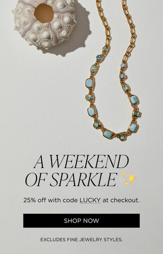 A weekend of sparkle. 25% off with code LUCKY at checkout. Excludes fine jewelry. Image of Nadri's Cabarete blue stone necklace next to a seashell.