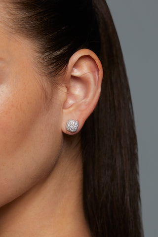 CLOSE UP IMAGE OF MODEL'S EAR WITH CRUSHED CUSHION STUD EARRINGS ON. 