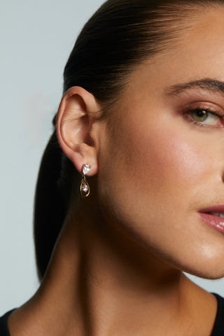 CLOSE UP OF MODEL WEARING IT GIRL SHORT DROP EARRINGS