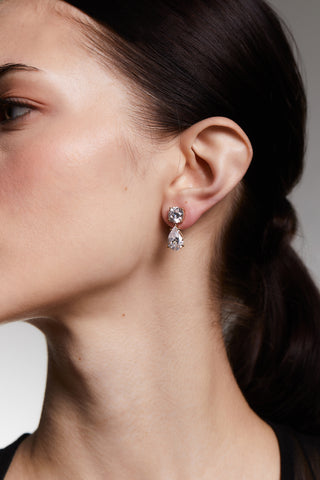 CLOSE UP OF A MODEL’S PROFILE WEARING MAIDEN PEAR DROP EARRINGS WITH HER HAIR IN A PONYTAIL